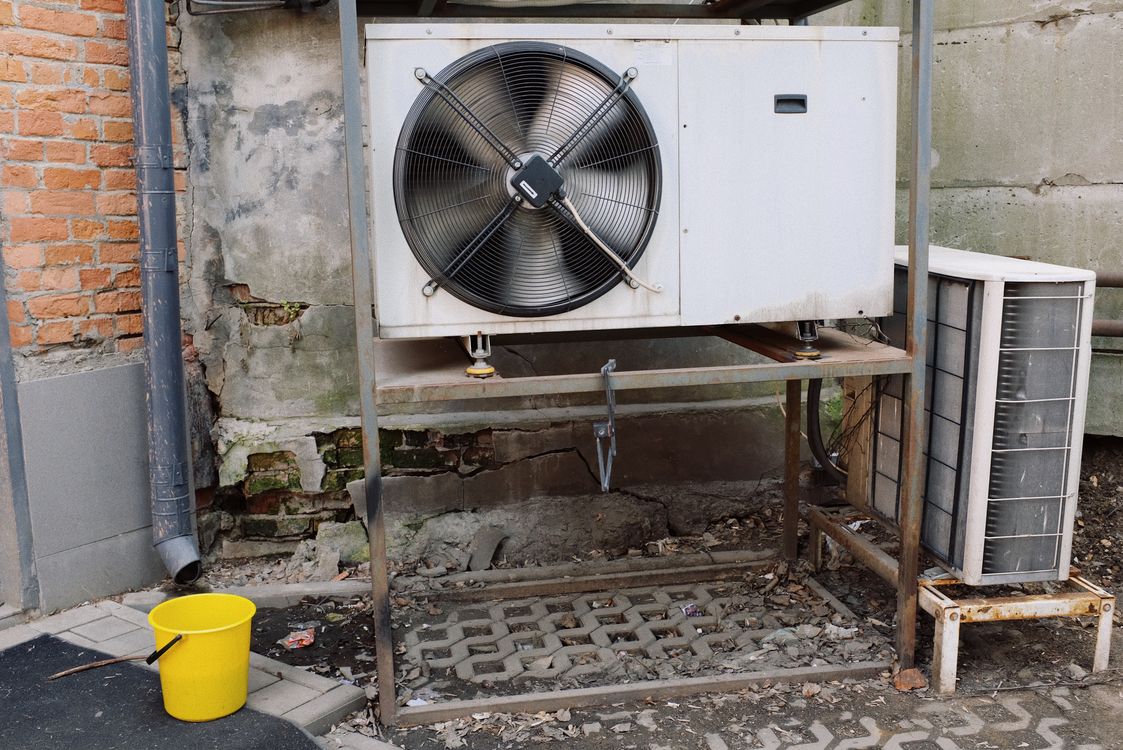 HVAC crew installing condenser unit — hvac equipment tracking keeps installations on schedule